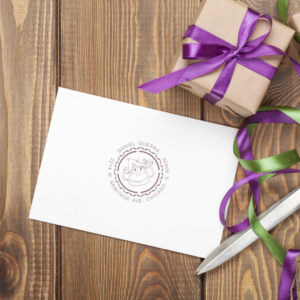 Personalized return address rubber stamp on envelope with cow logo, perfect for custom gift packaging and mailing.