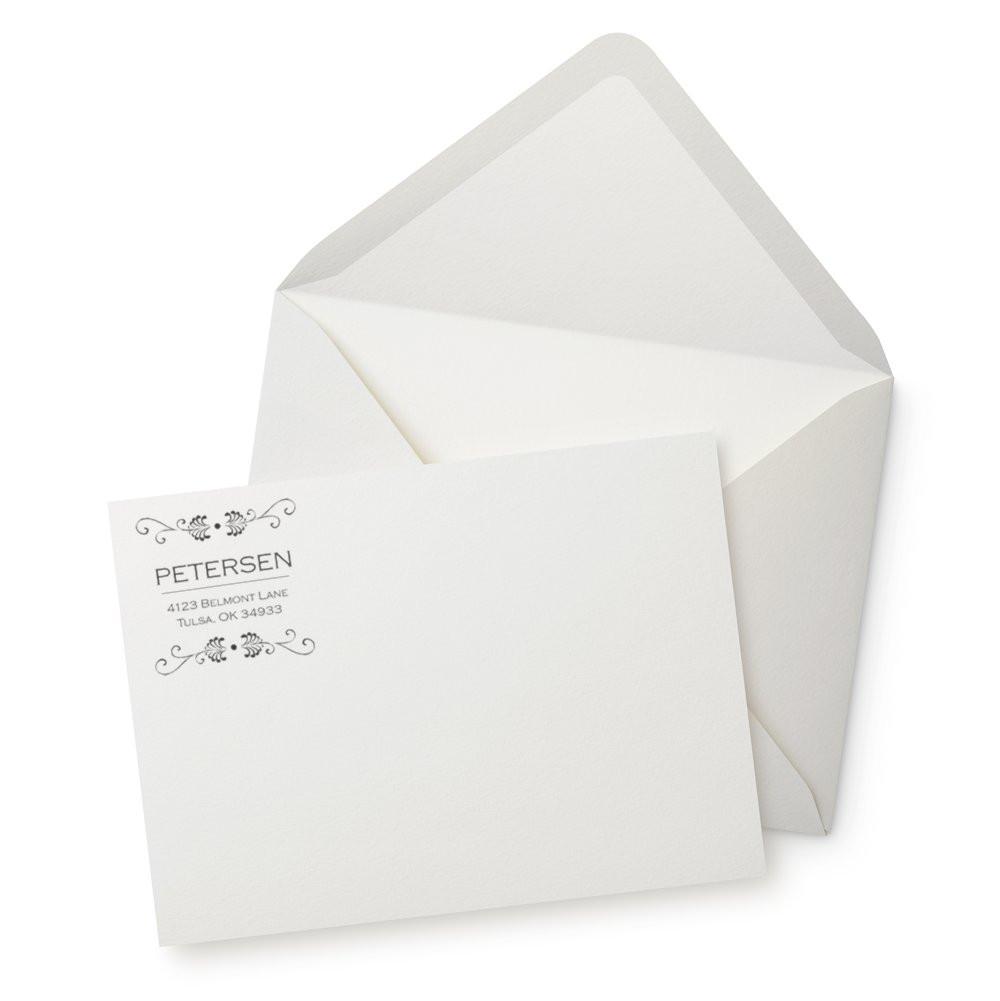 Custom return address rubber stamp on white envelope and stationery card with elegant floral design