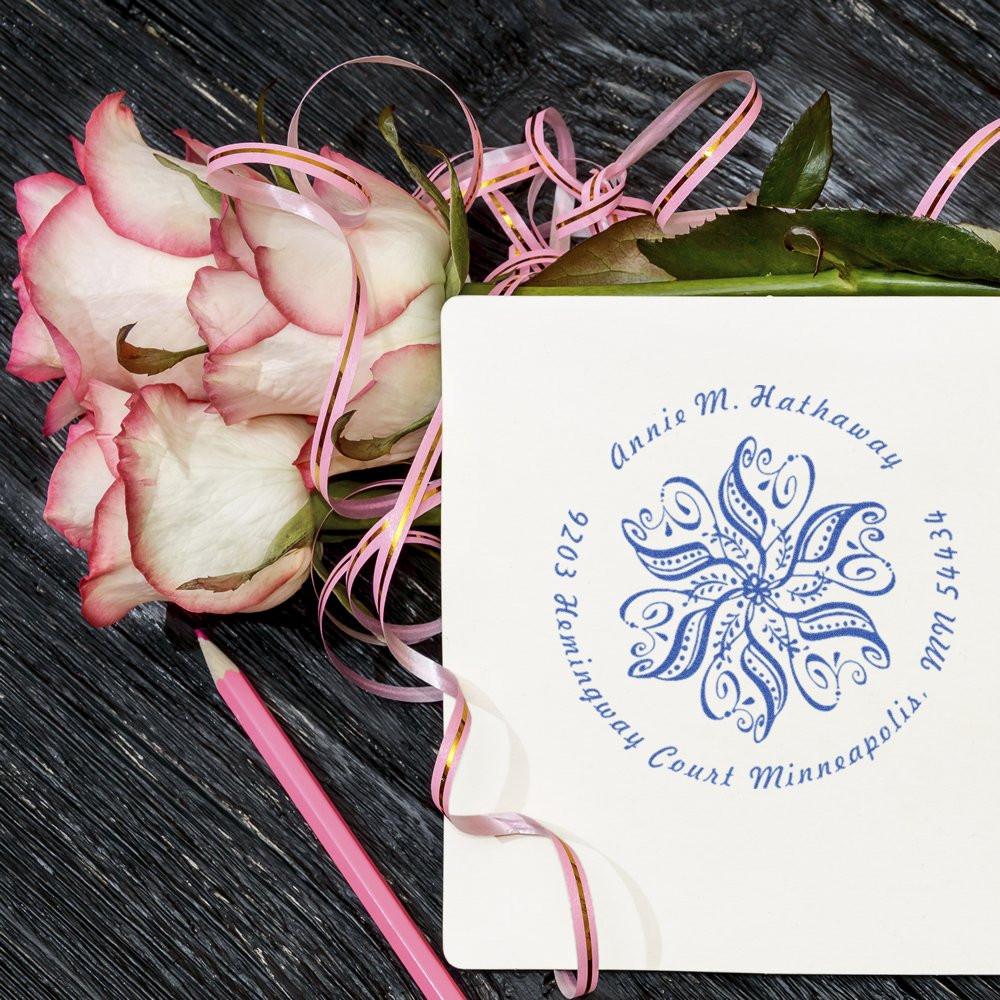 Personalized return address rubber stamp with floral monogram on wedding stationery, styled with roses for custom cards