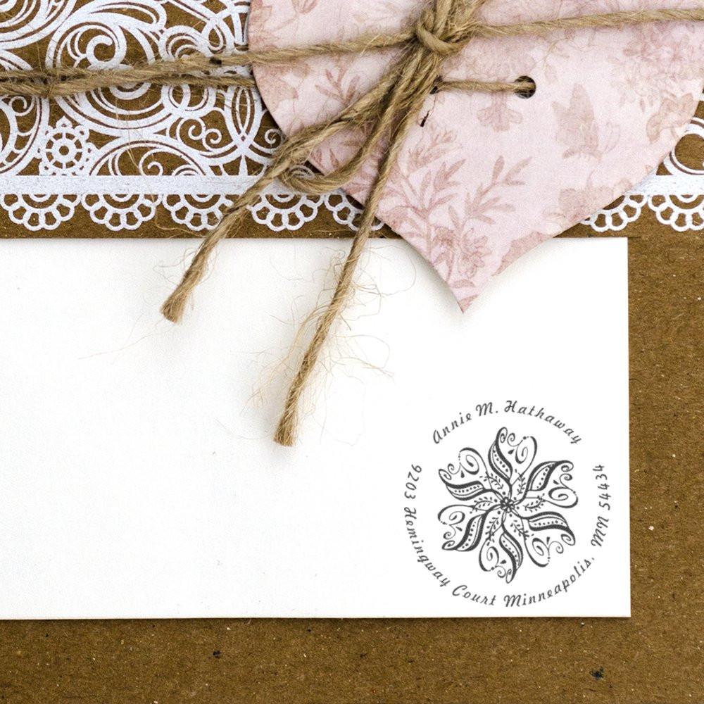 Custom floral rubber return address stamp on wedding envelope for personalized invitations and stationery.