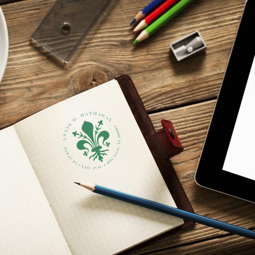 Custom rubber stamp logo on notebook page, showcasing personalized branded stationery for office or creative use.