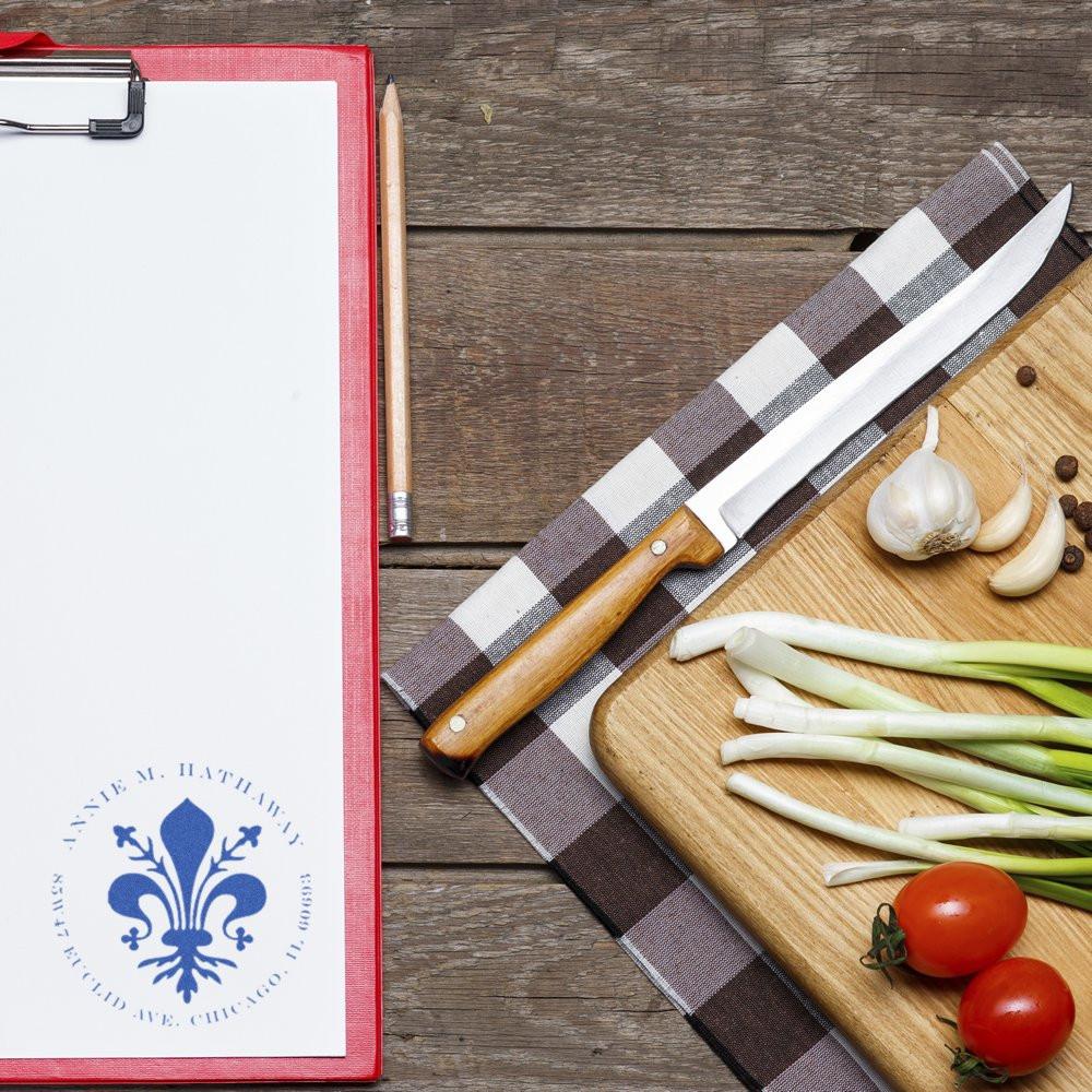 Custom rubber stamp logo on clipboard paper, ideal for branded stationery and business packaging.