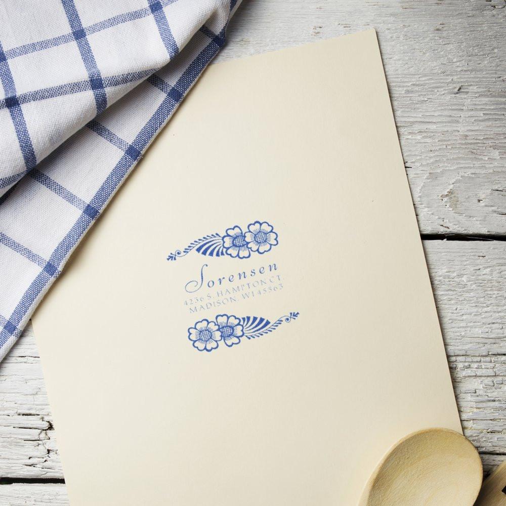 Personalized floral return address rubber stamp impression on cream stationery, ideal for wedding invitations and envelopes.