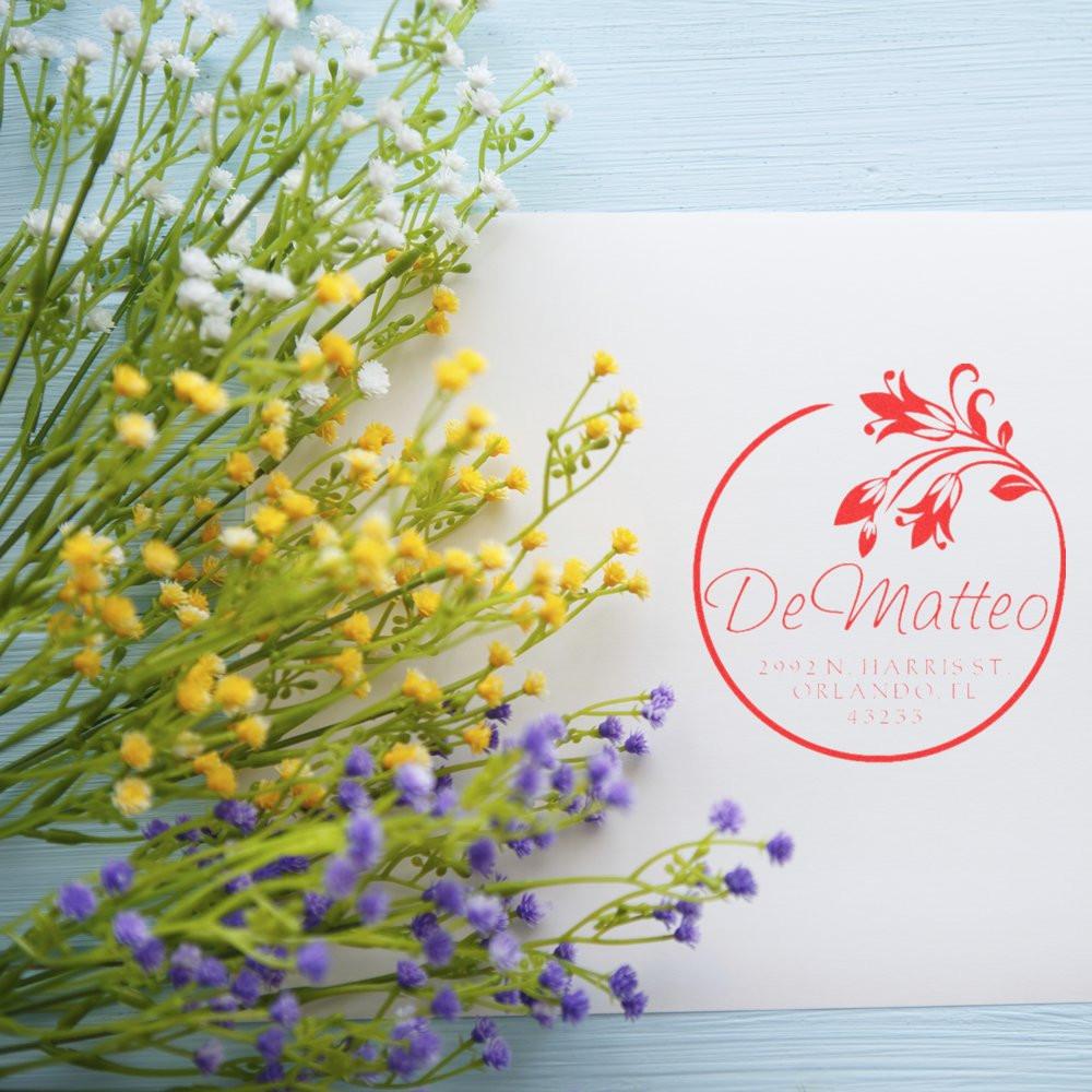 Custom floral address rubber stamp for wedding stationery, featuring DeMatteo name and Orlando, FL mailing address.