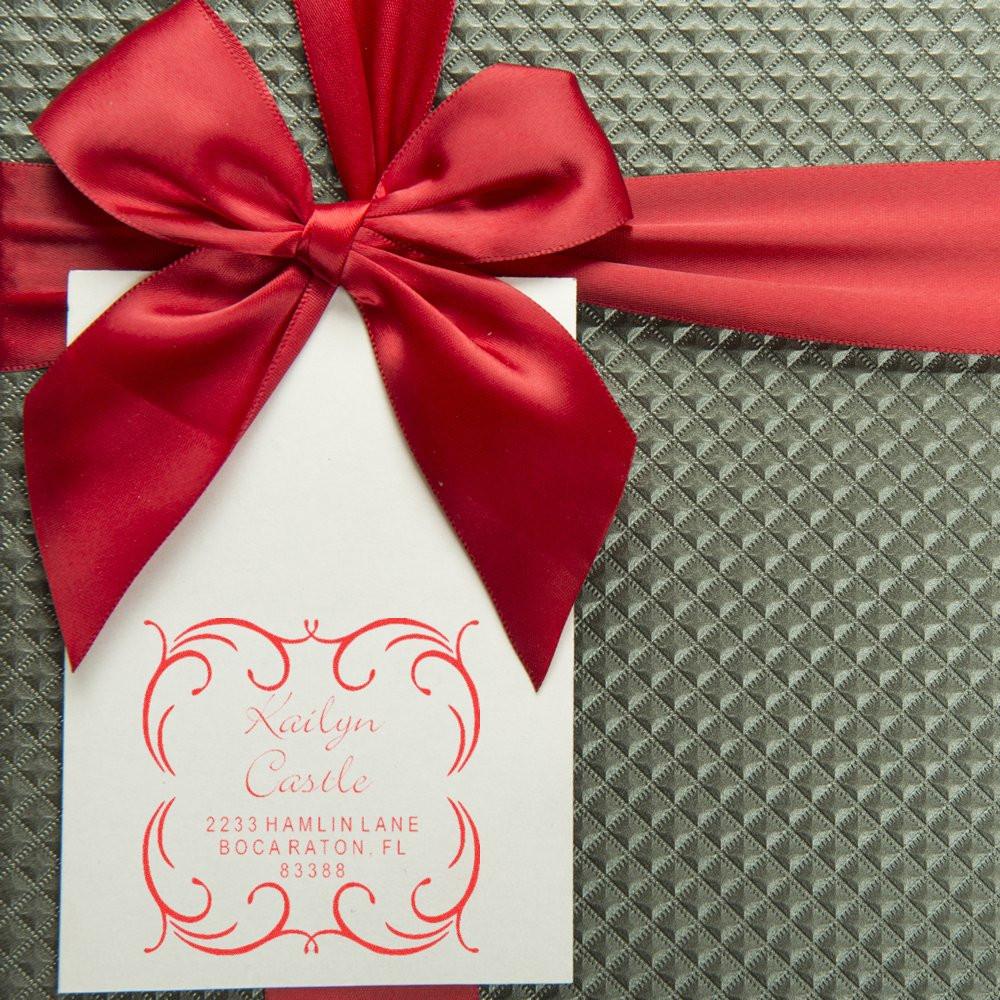 Personalized return address rubber stamp on a gift card, tied with red ribbon bow, featuring custom name and Boca Raton, FL.