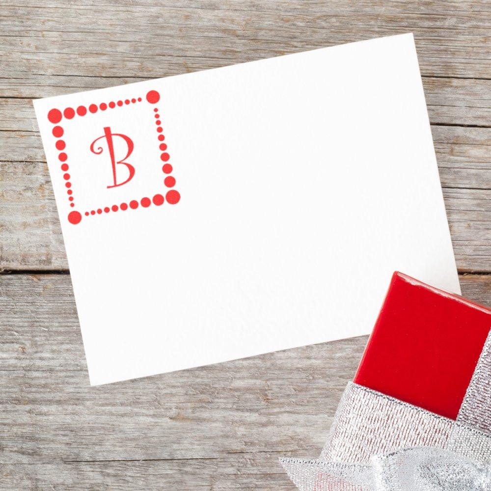 Blank personalized monogram greeting card with red B and gift box on rustic wood background