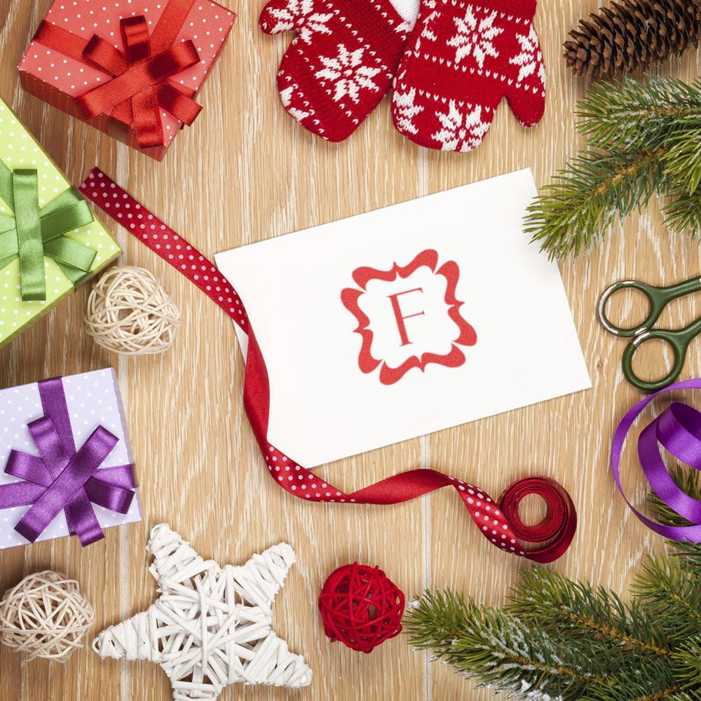 Custom rubber stamp monogram on holiday gift card, highlighting personalized Christmas gift wrapping and packaging ideas.