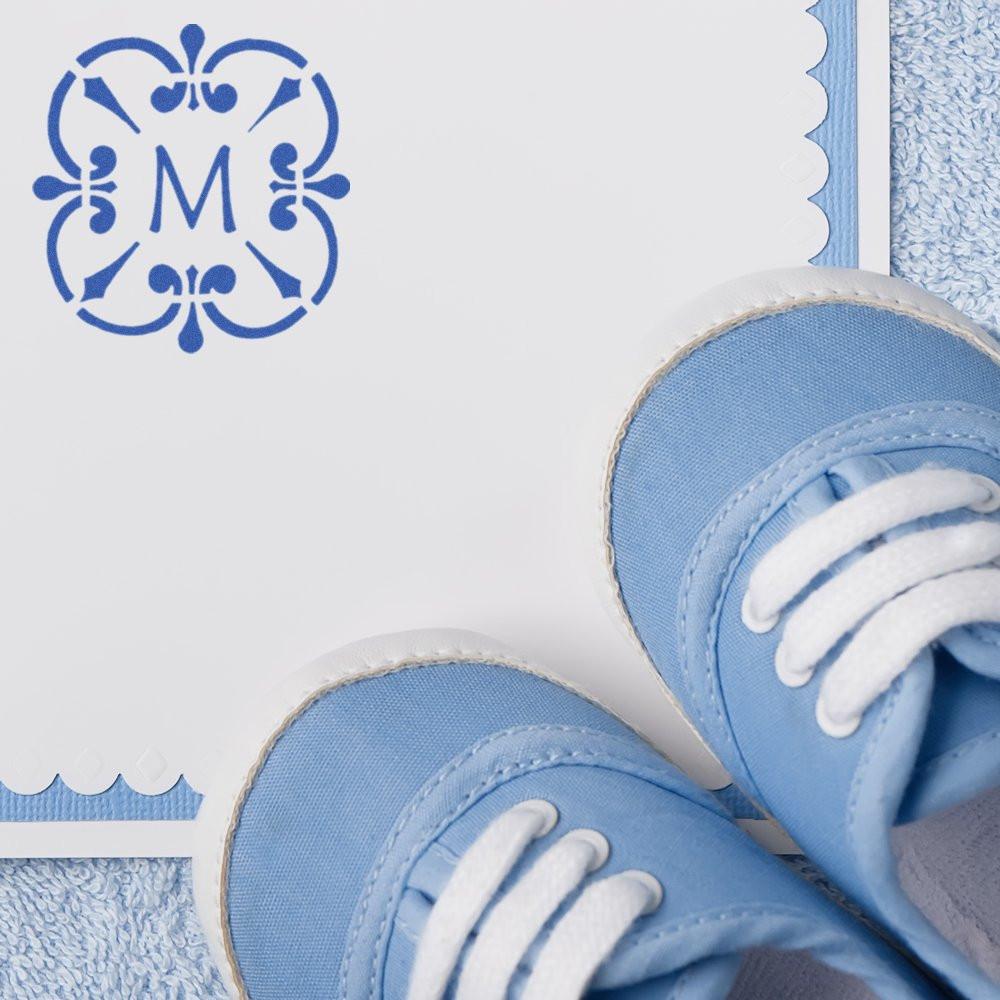 Custom monogram rubber stamp with blue floral letter M design for personalized stationery and wedding-style cards