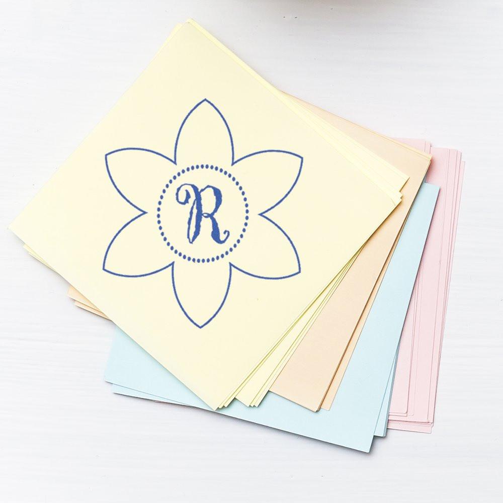 Floral monogram R rubber stamp on pastel stationery cards for personalized invitations, notes, and craft projects.