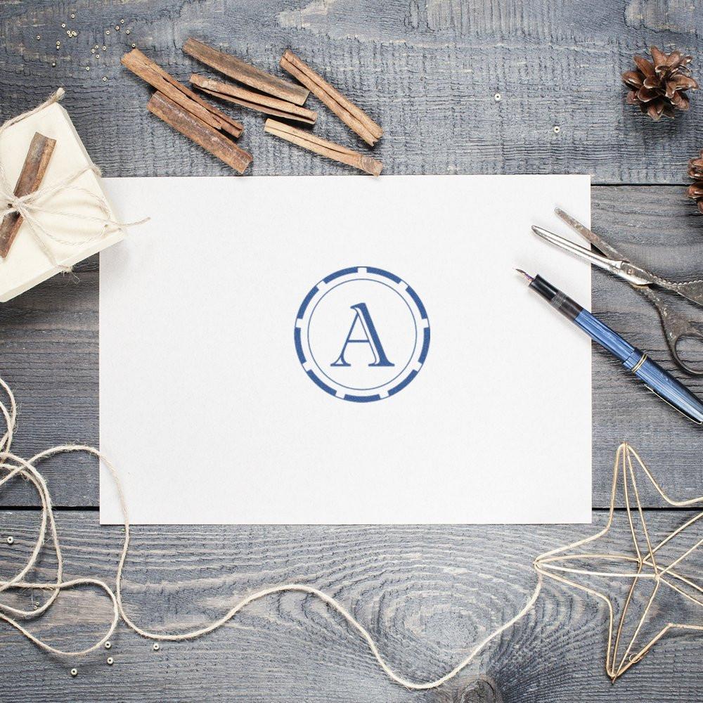 Custom monogram rubber stamp with letter A on stationery, ideal for personalized cards, gift tags, and craft projects.