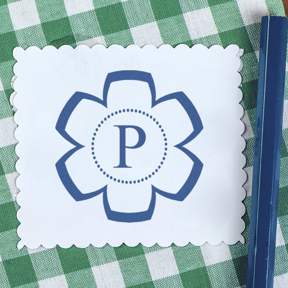 Personalized flower monogram rubber stamp with letter P on white scalloped card, ideal for custom stationery and gifts.