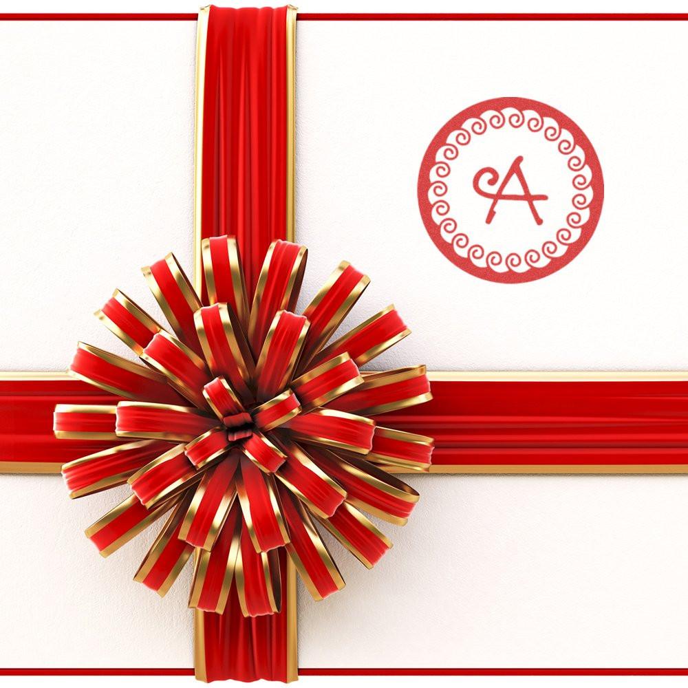 Red and gold ribbon bow with monogram A on white wallfestive gift or doorway decoration for weddings and celebrations.