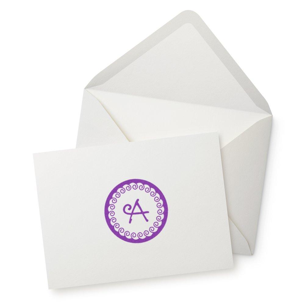 Custom monogram rubber stamp with purple letter A on greeting card and envelope for wedding or stationery branding