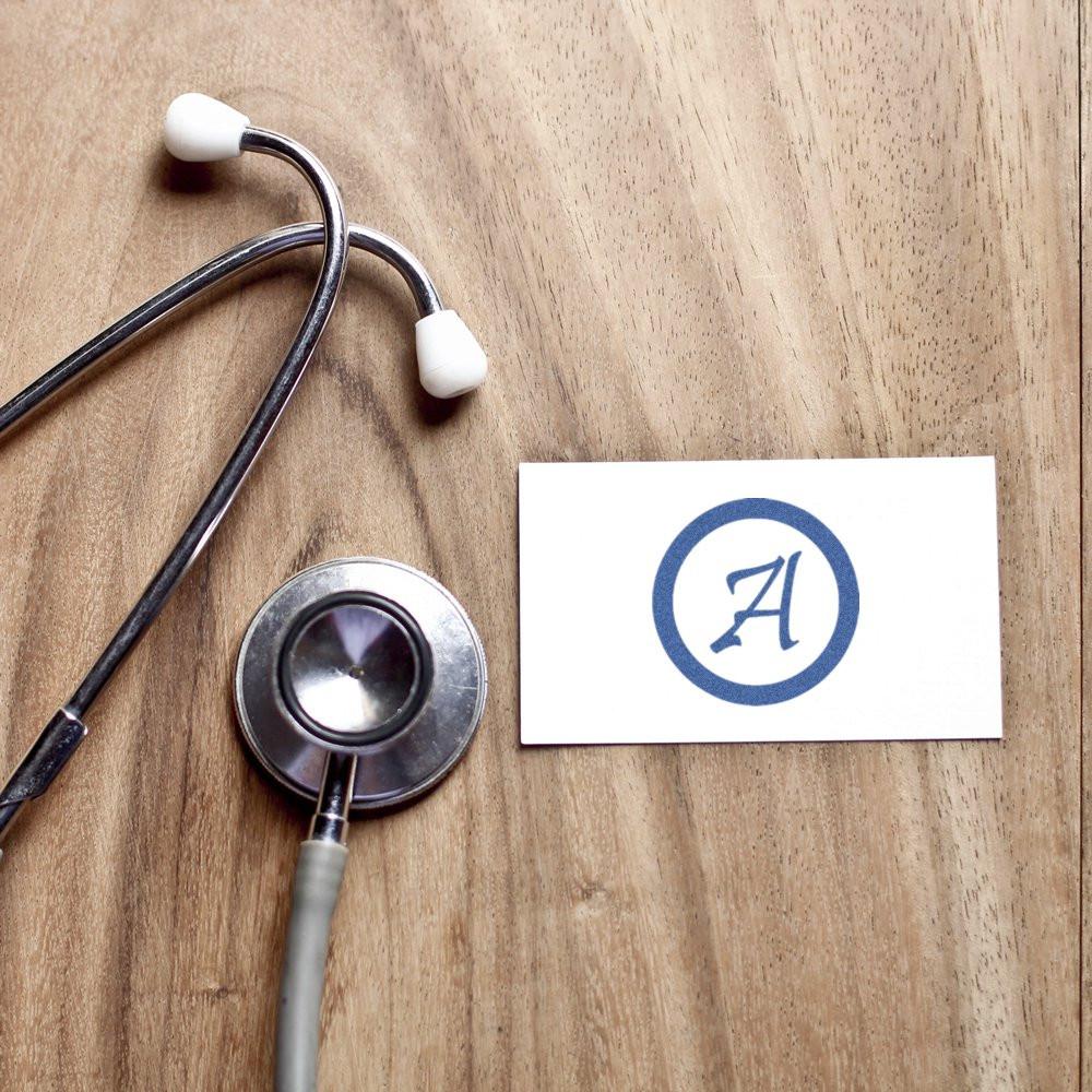 Custom rubber stamp logo beside stethoscope for medical office branding, doctor stationery, and clinic correspondence.
