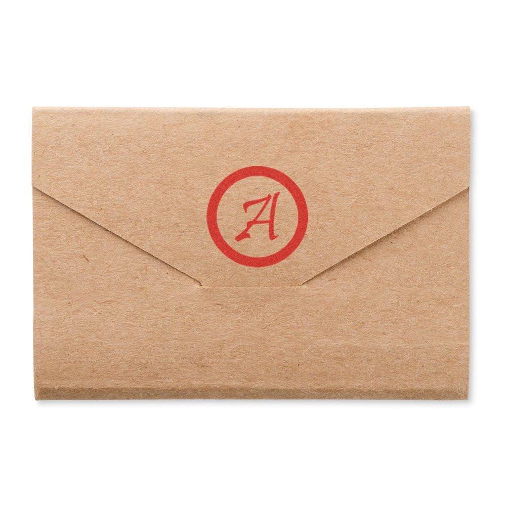 Custom rubber stamp monogram on a kraft envelope, ideal for personalized branding or return address use.