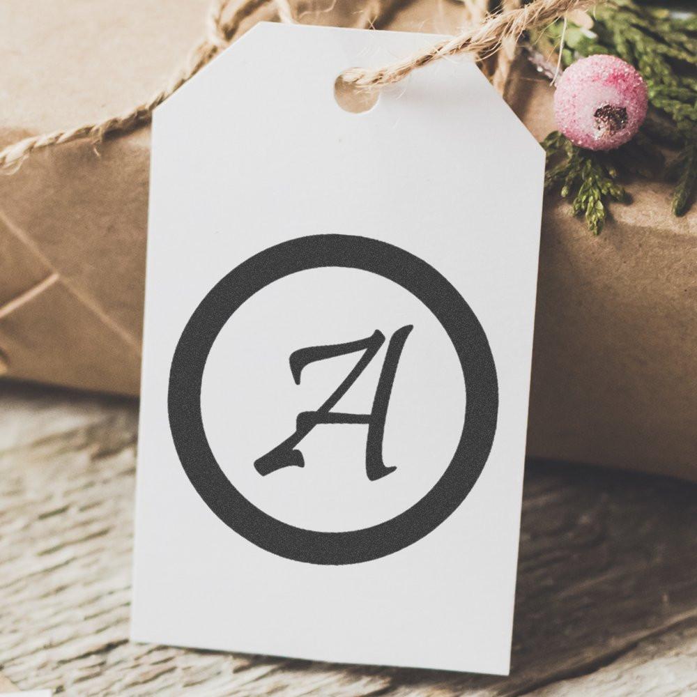 Custom A monogram rubber stamp on white gift tag for elegant holiday gift wrapping