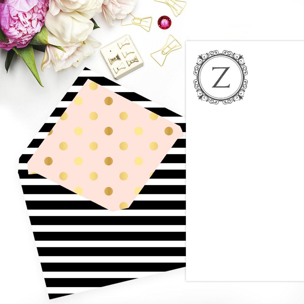 Custom monogram Z rubber stamp mockup on black-and-white striped stationery with pink polka dot envelope.