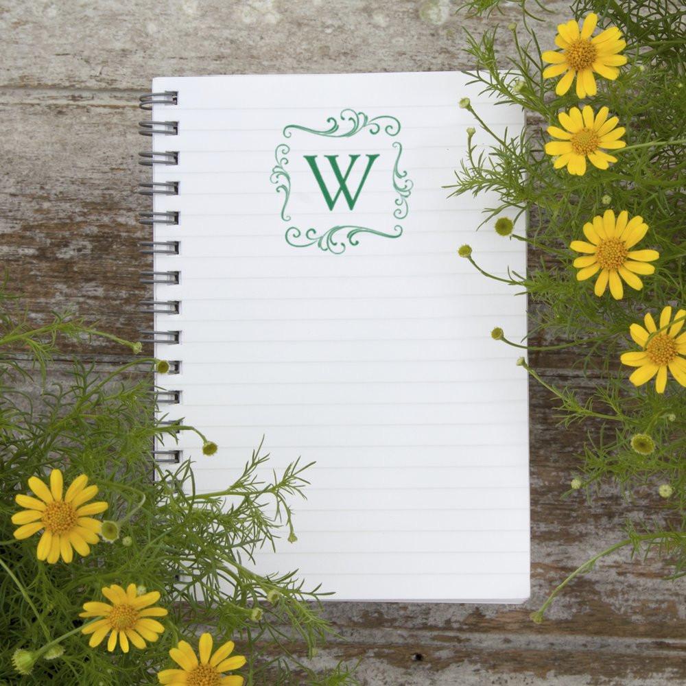 Custom decorative monogram W rubber stamp on spiral notebook, perfect for personalized stationery and wedding crafts.