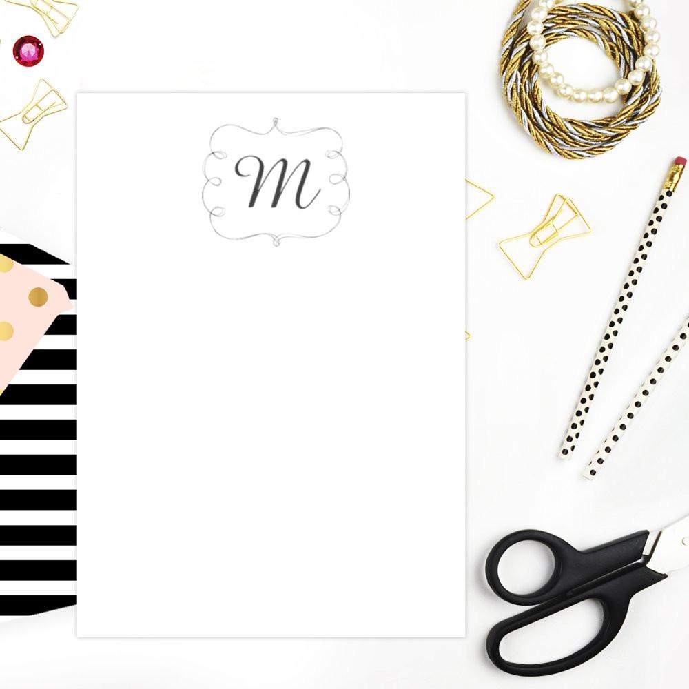 Custom monogram rubber stamp mockup on blank stationery card with elegant desk accessories for wedding and business branding.