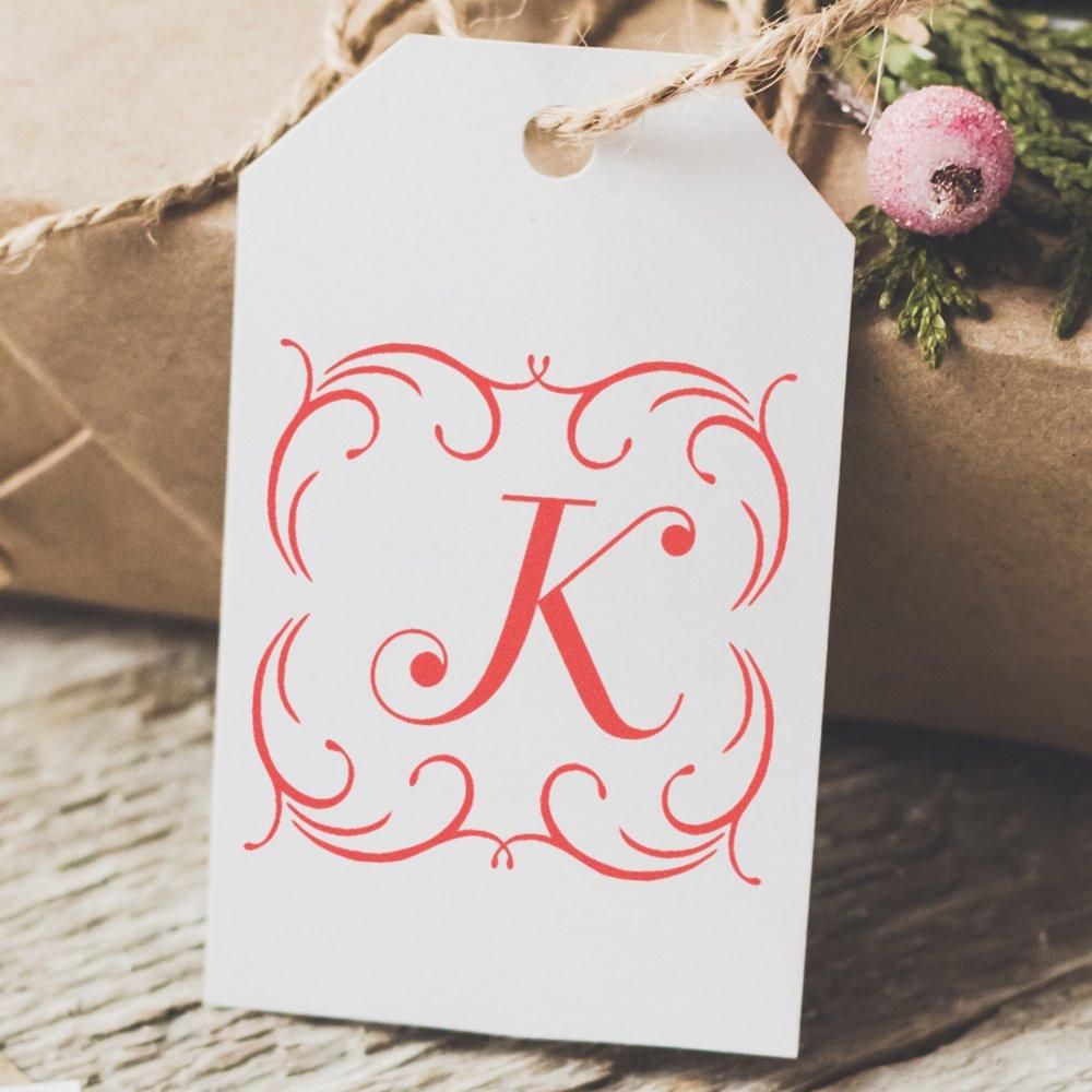 Personalized K monogram rubber stamp on a gift tag, ideal for custom wedding favors and holiday packaging.