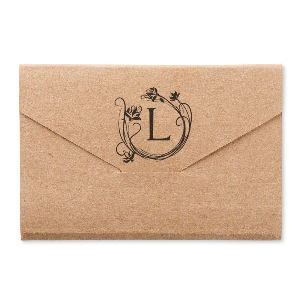 Custom floral monogram L rubber stamp on kraft envelope for wedding invitations, stationery, and branding.
