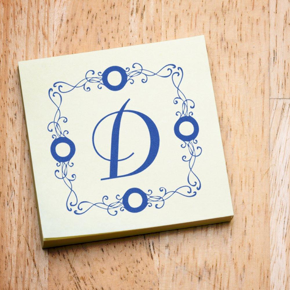 Custom rubber stamp with monogram letter D and ornate floral border for personalized stationery, wedding invitations, and branding.