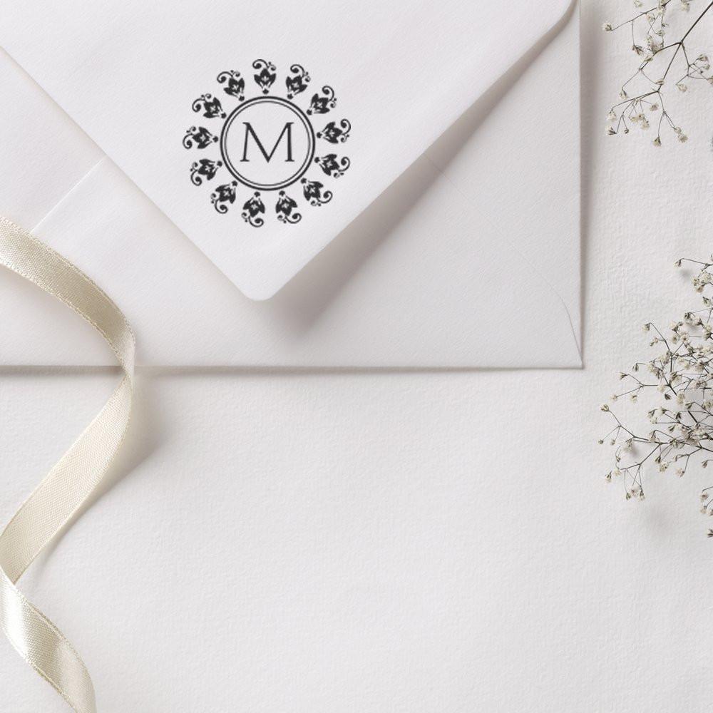 Elegant custom monogram rubber stamp on white wedding invitation envelope