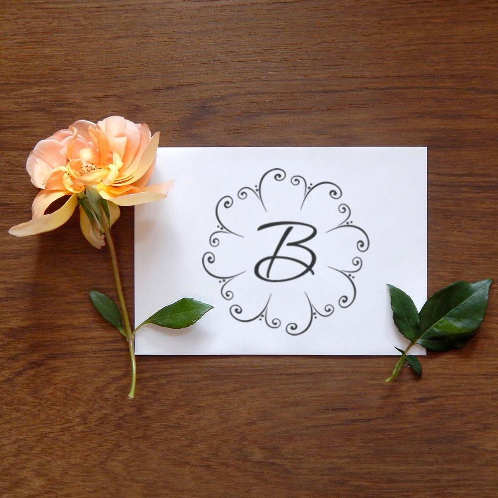 Decorative monogram B rubber stamp design with floral swirl wreath for weddings, branding, and stationery.