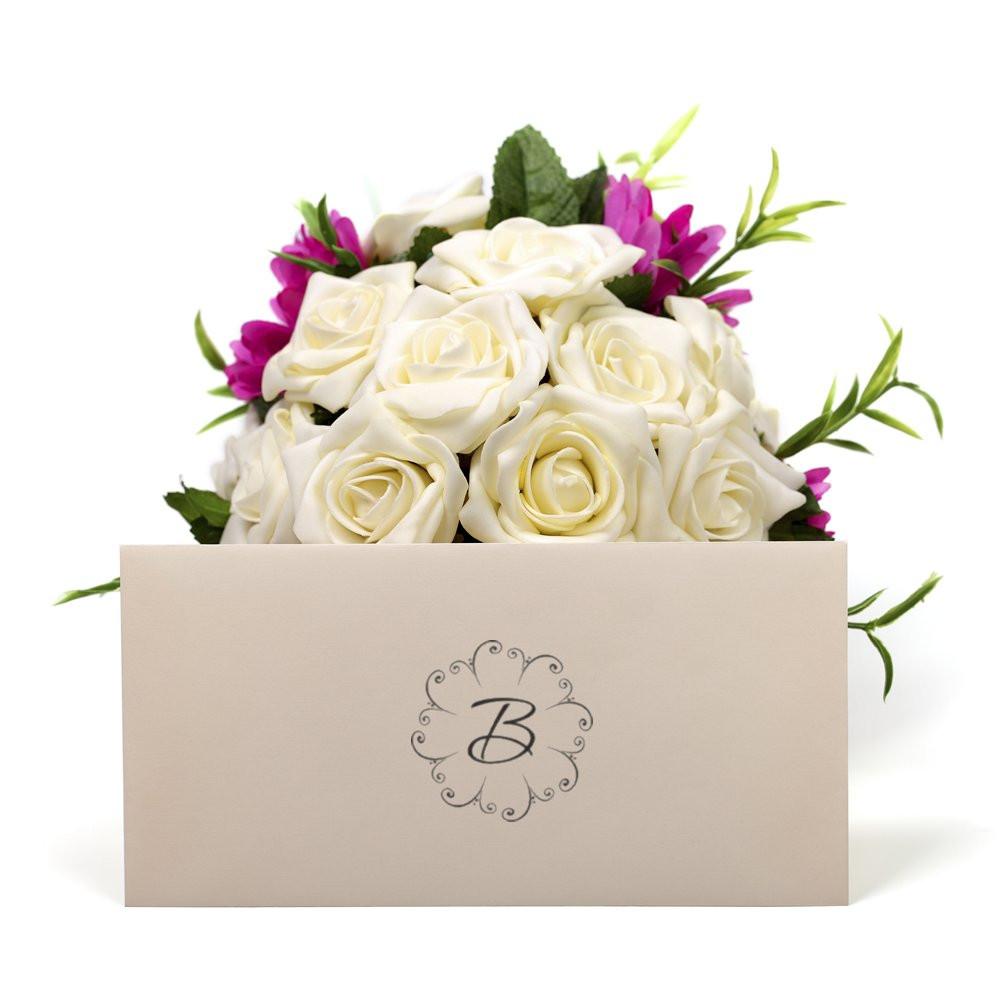 Custom floral monogram rubber stamp with letter B on a wedding gift bag for elegant bridal bouquet packaging.