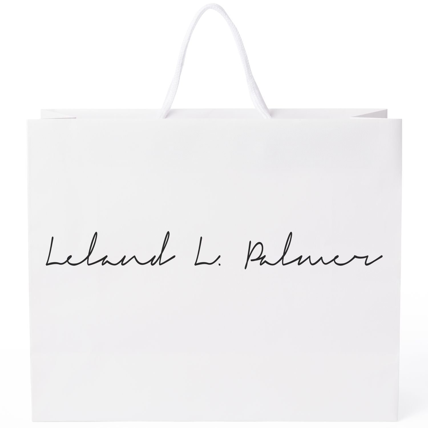 White shopping bag with rope handles, branded script lettering for Lebundclean product packaging for retail or gifts.