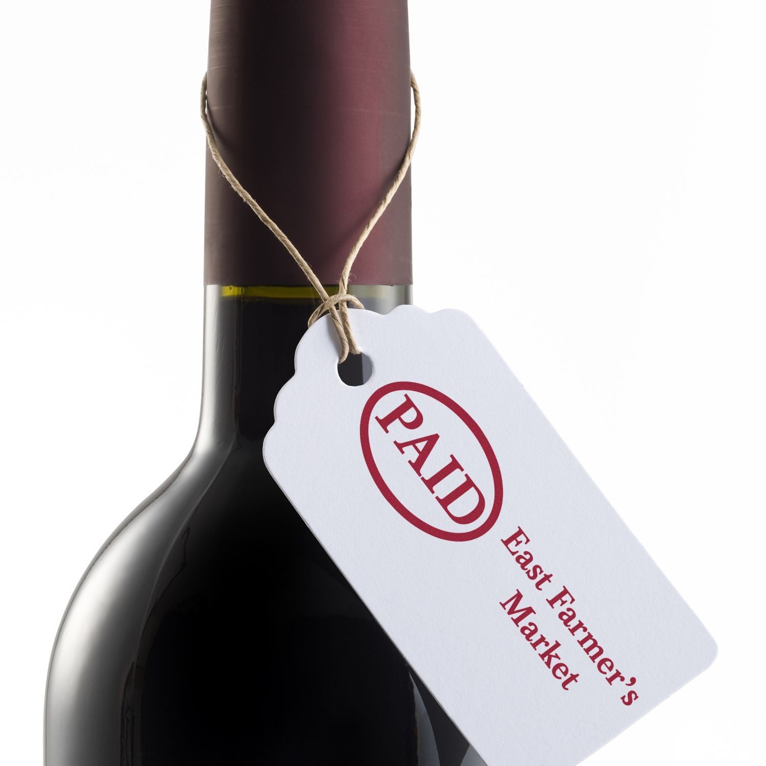 Wine bottle with PAID tag from East Farmers Market on a white background