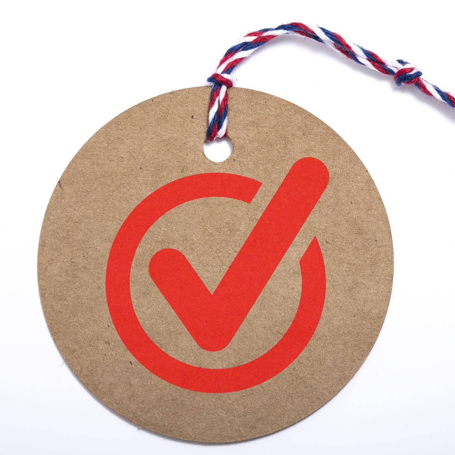 Round cardboard tag with red checkmark symbol and red, white, and blue hanging string on white background