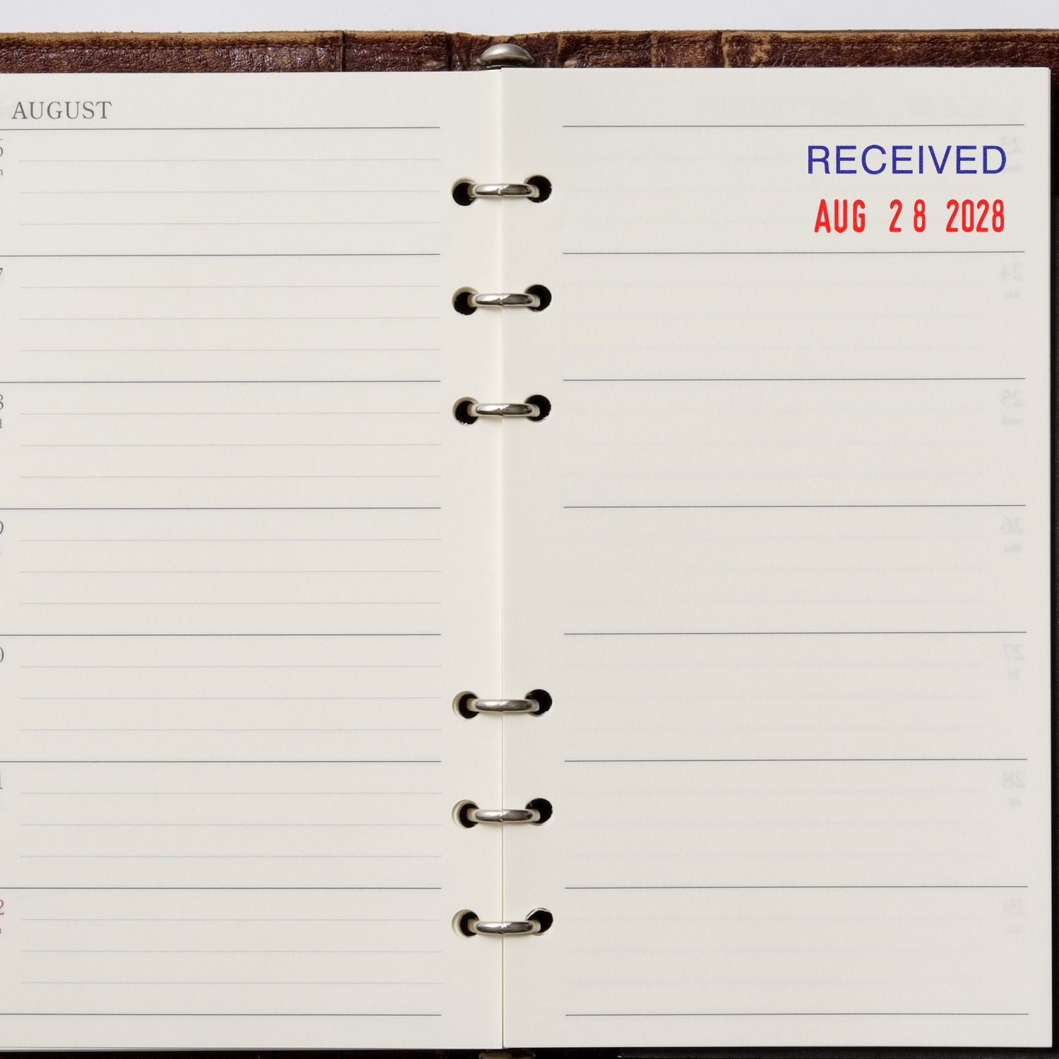 Open August planner page with Received Aug 28 2028 date stamp on a ring-bound diary.