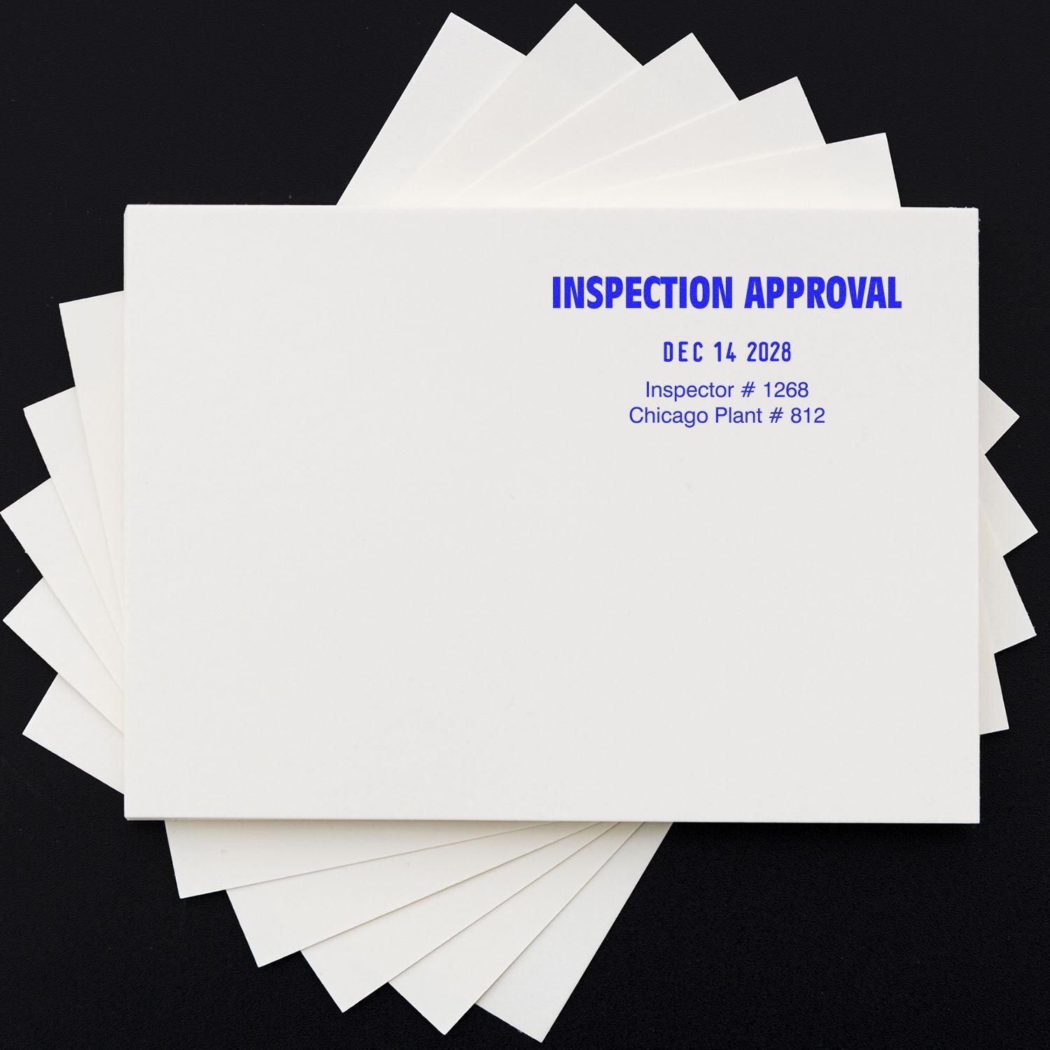 Inspection approval documents folder with stamped inspection approval, date, inspector number, and Chicago plant information on white paperwork.