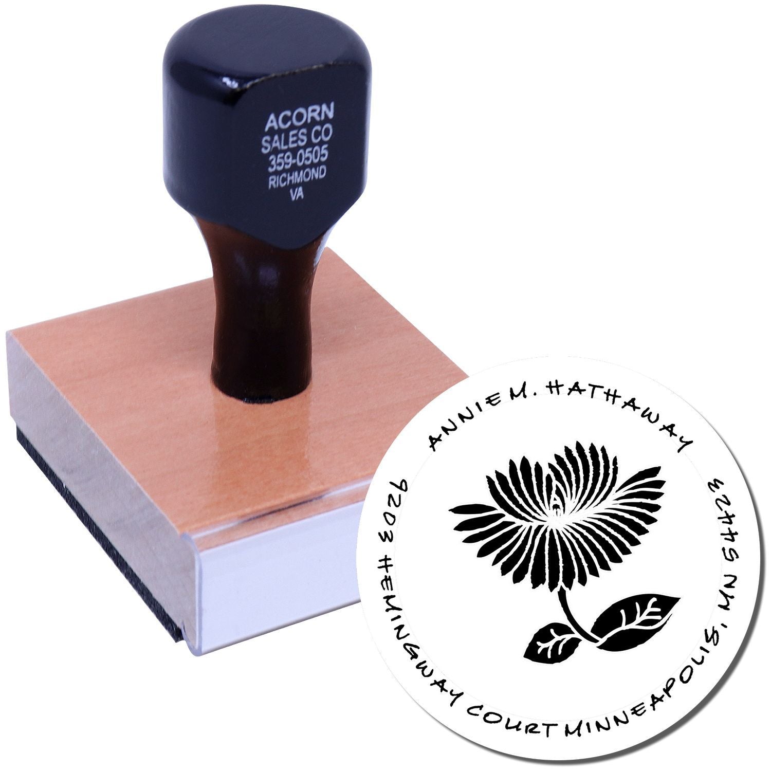 Custom rubber stamp with floral logo design and circular name imprint for business branding and stationery.