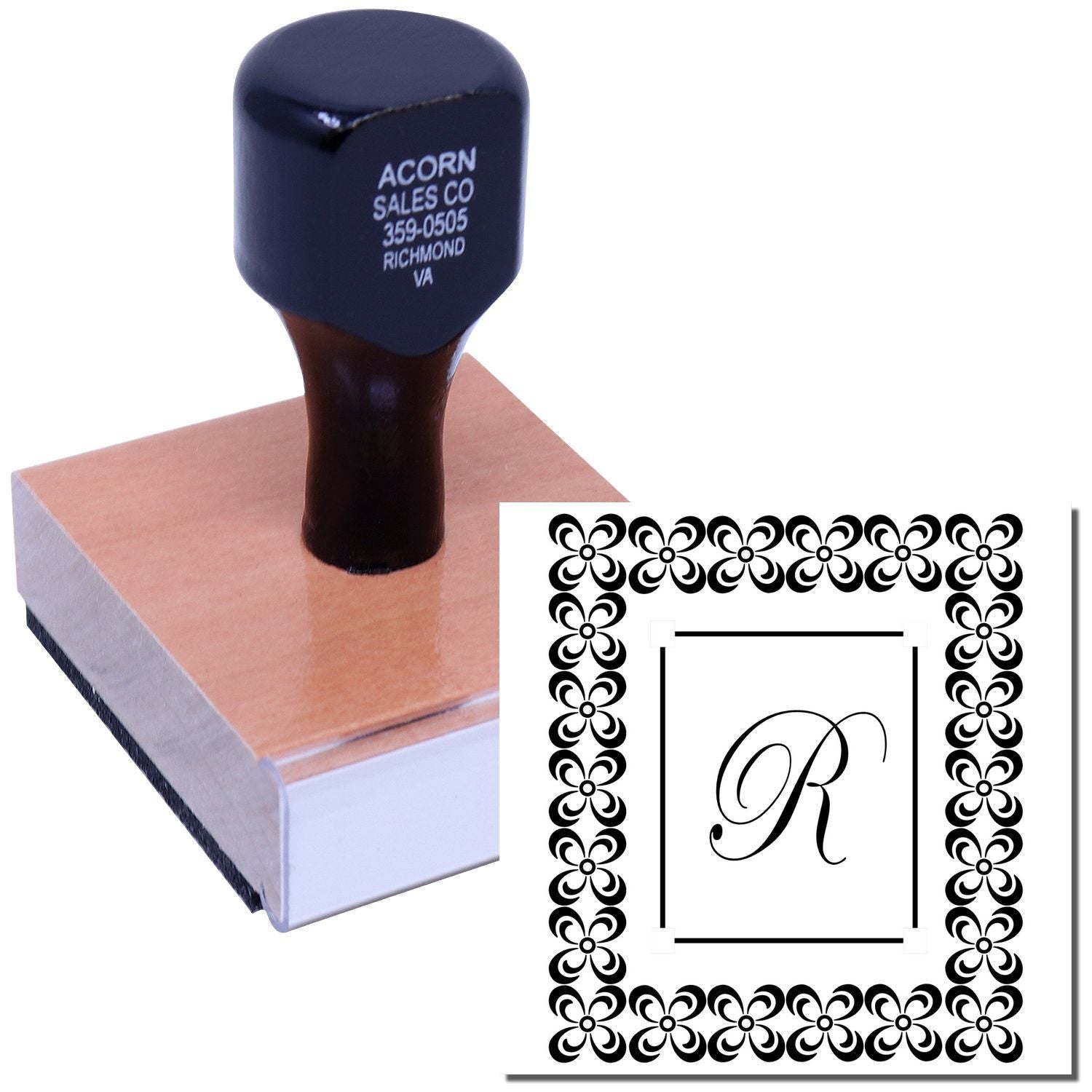 Custom rubber stamp with floral border and monogram R, shown with ink pad for personalized stationery or branding.