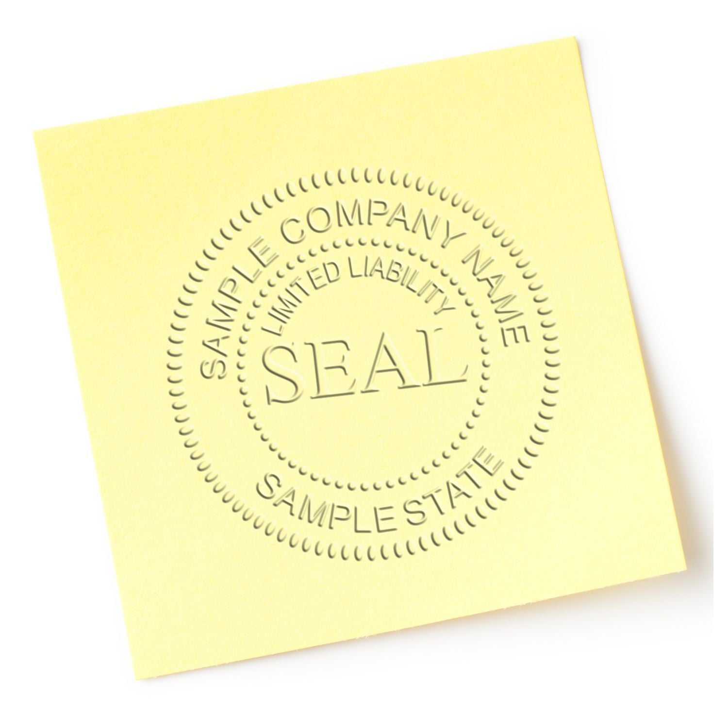 Yellow sticky note with embossed sample company seal and limited liability company text on white background