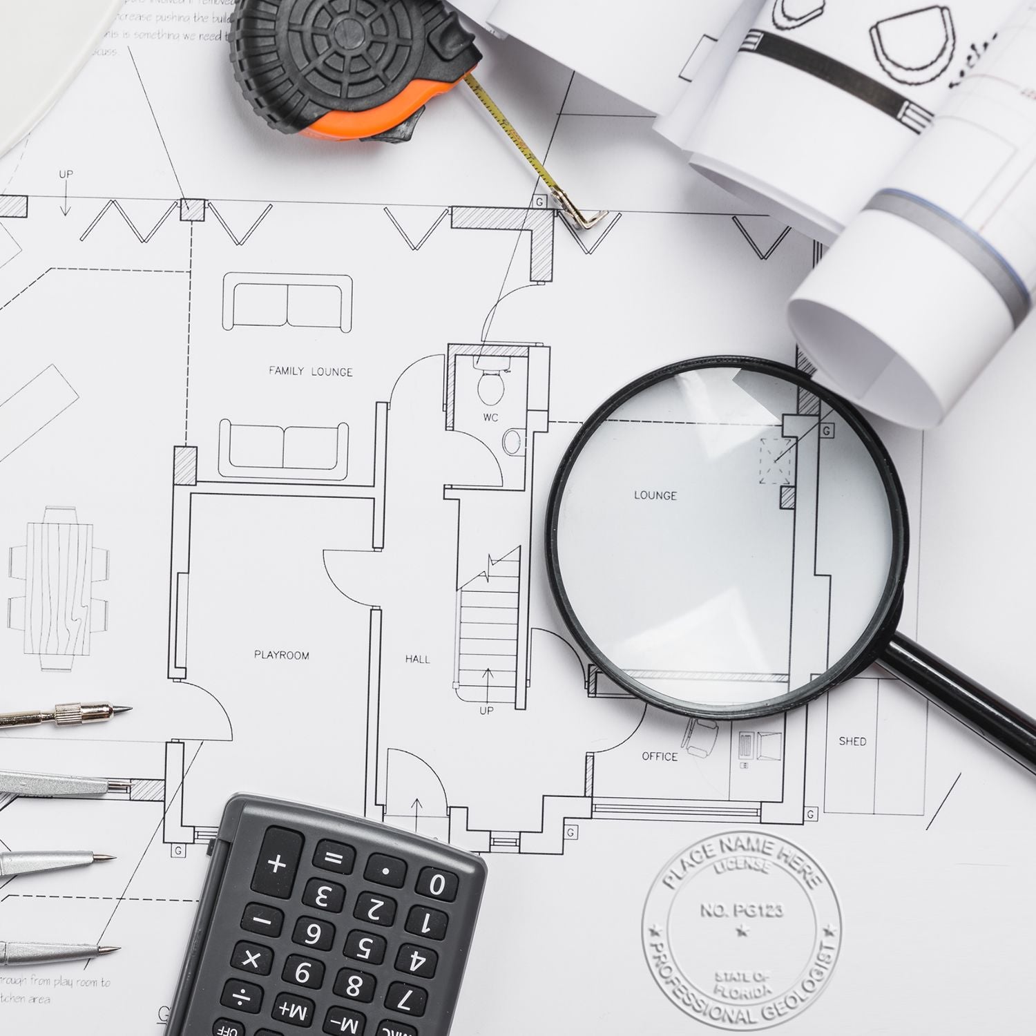 Architectural blueprint with tape measure, magnifying glass, calculator, and drafting tools for home renovation planning.