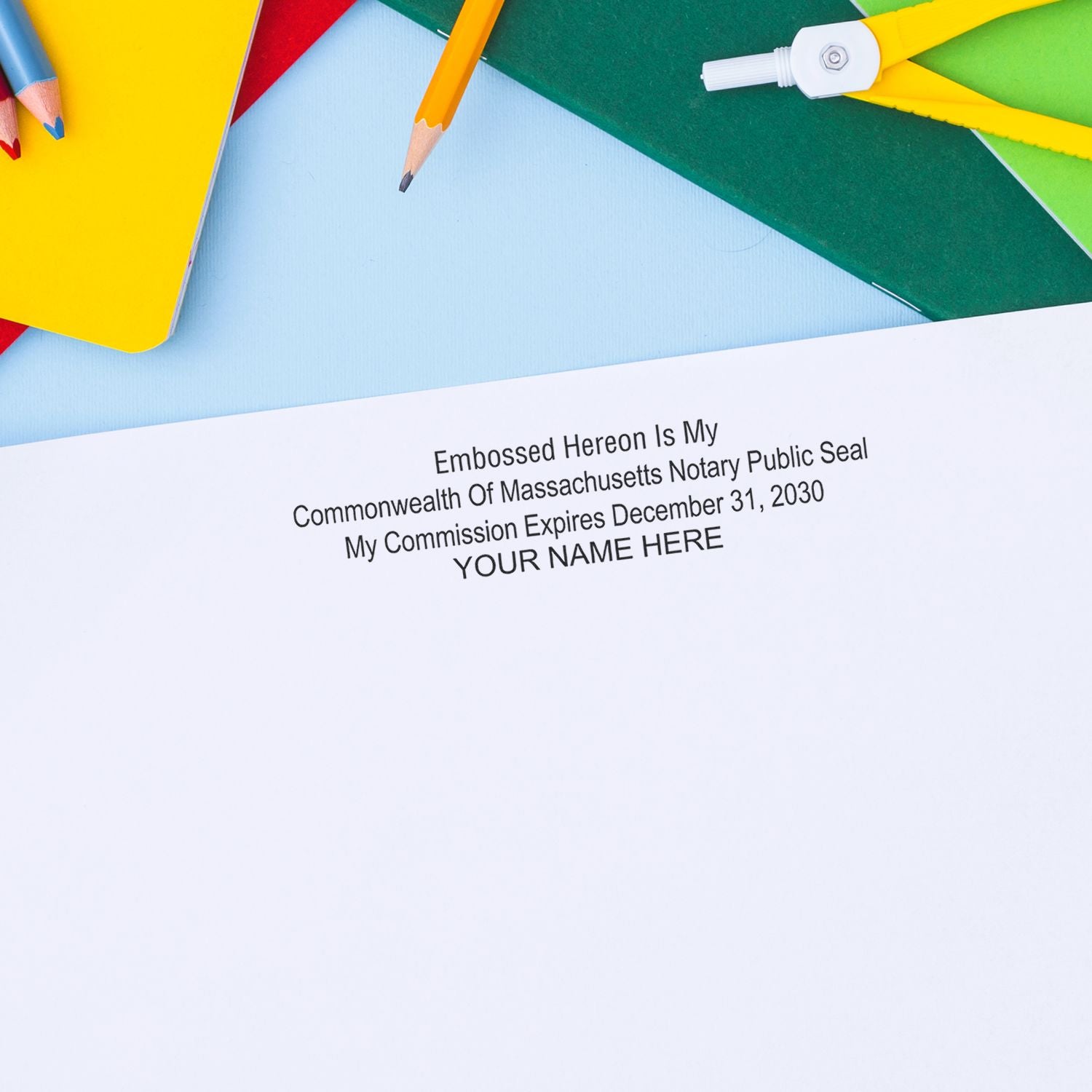 Massachusetts notary public seal on blank paper with colorful pencils and notebooks, professional office stationery concept