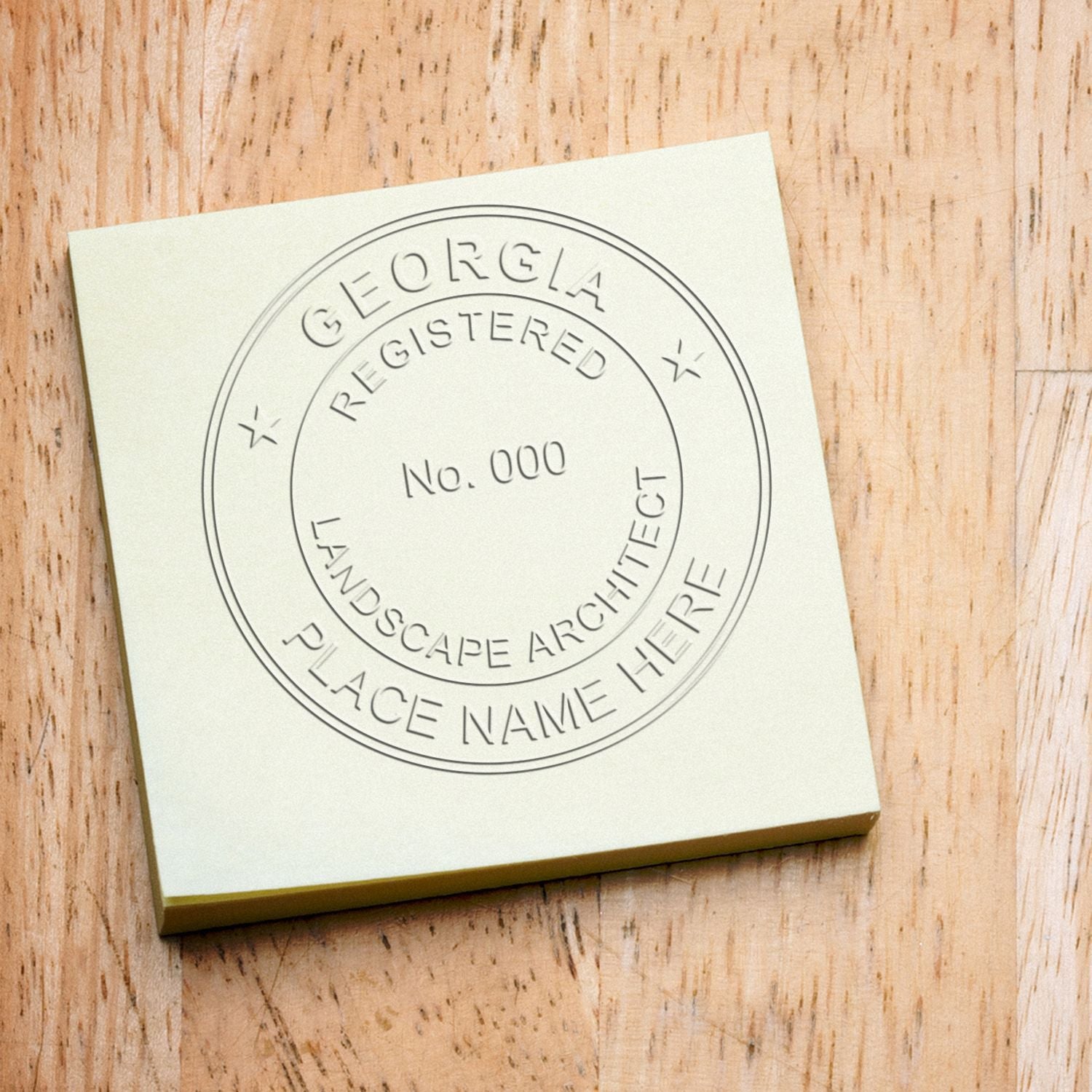 Custom Georgia registered landscape architect seal stamp on a wood surface with engraved branding design.