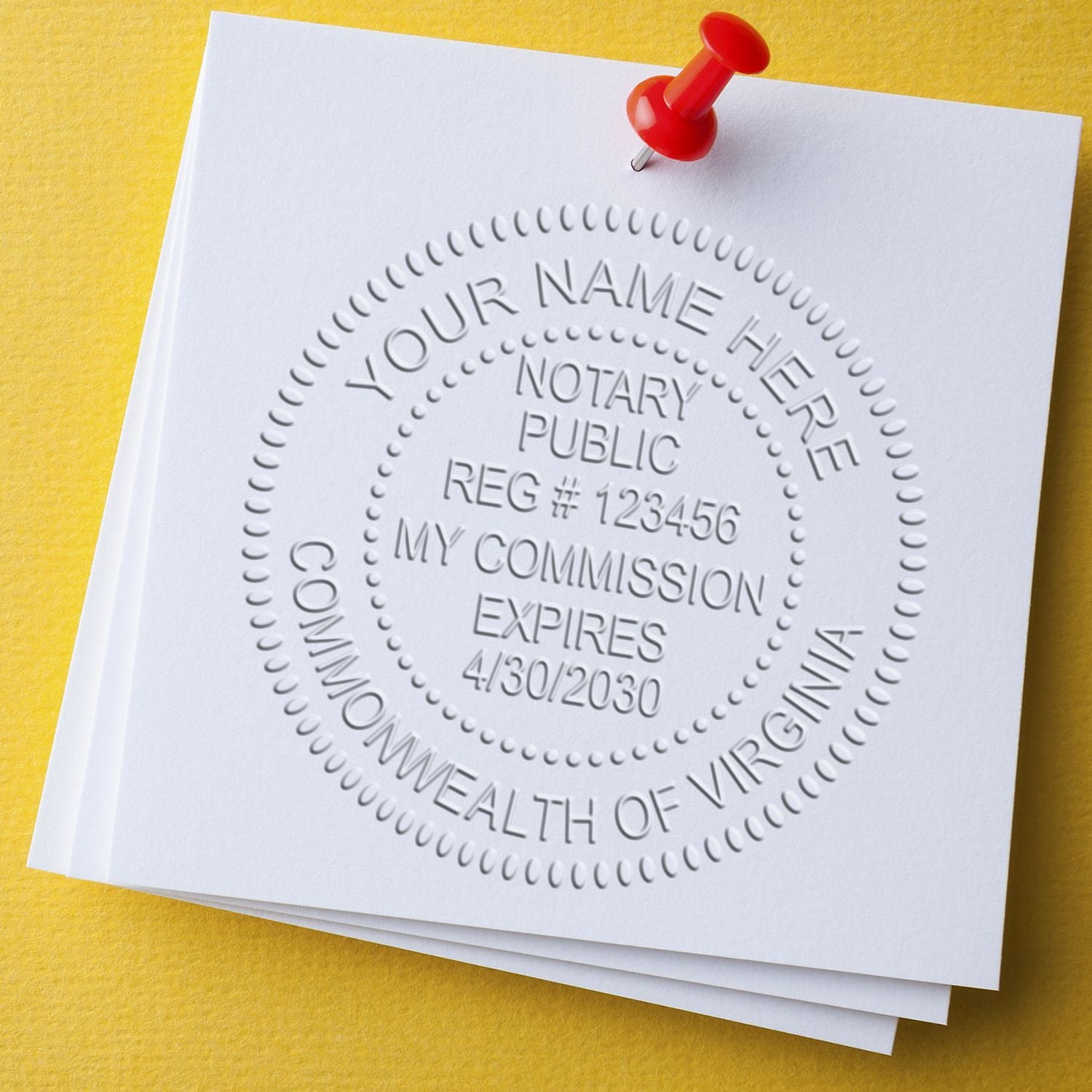 Notary public seal embossing on blank document with red push pin on yellow background.