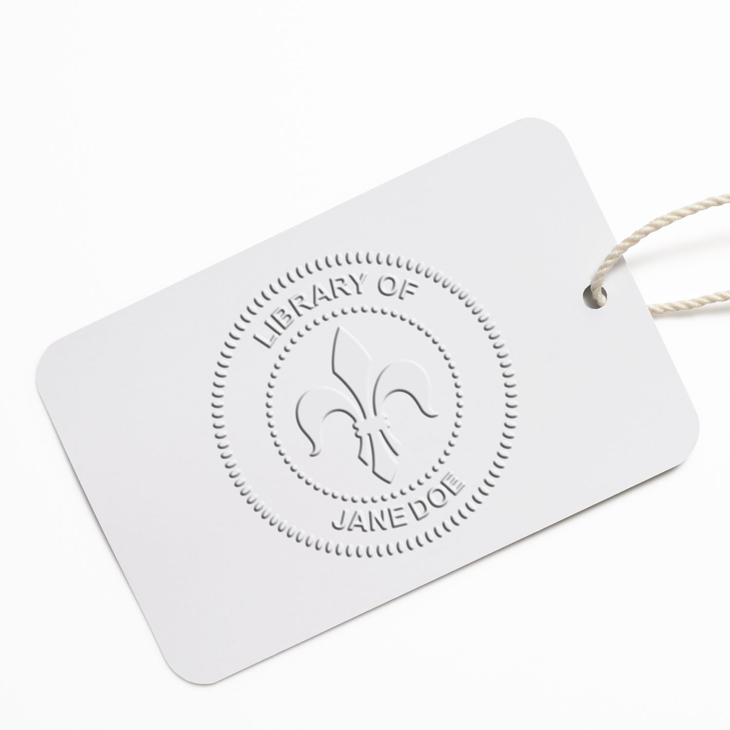 White custom library bookplate tag with embossed fleur-de-lis logo and string, featuring Library of Jane Doe branding