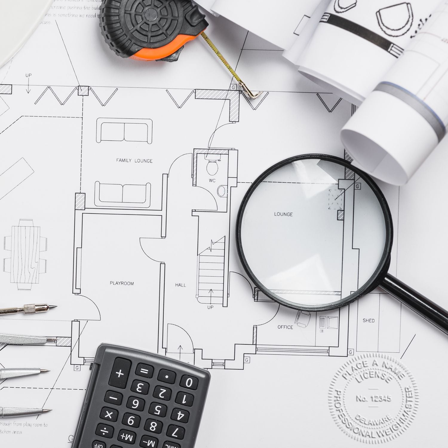 Architectural blueprint with magnifying glass, tape measure, calculator, and drafting tools for home renovation planning.