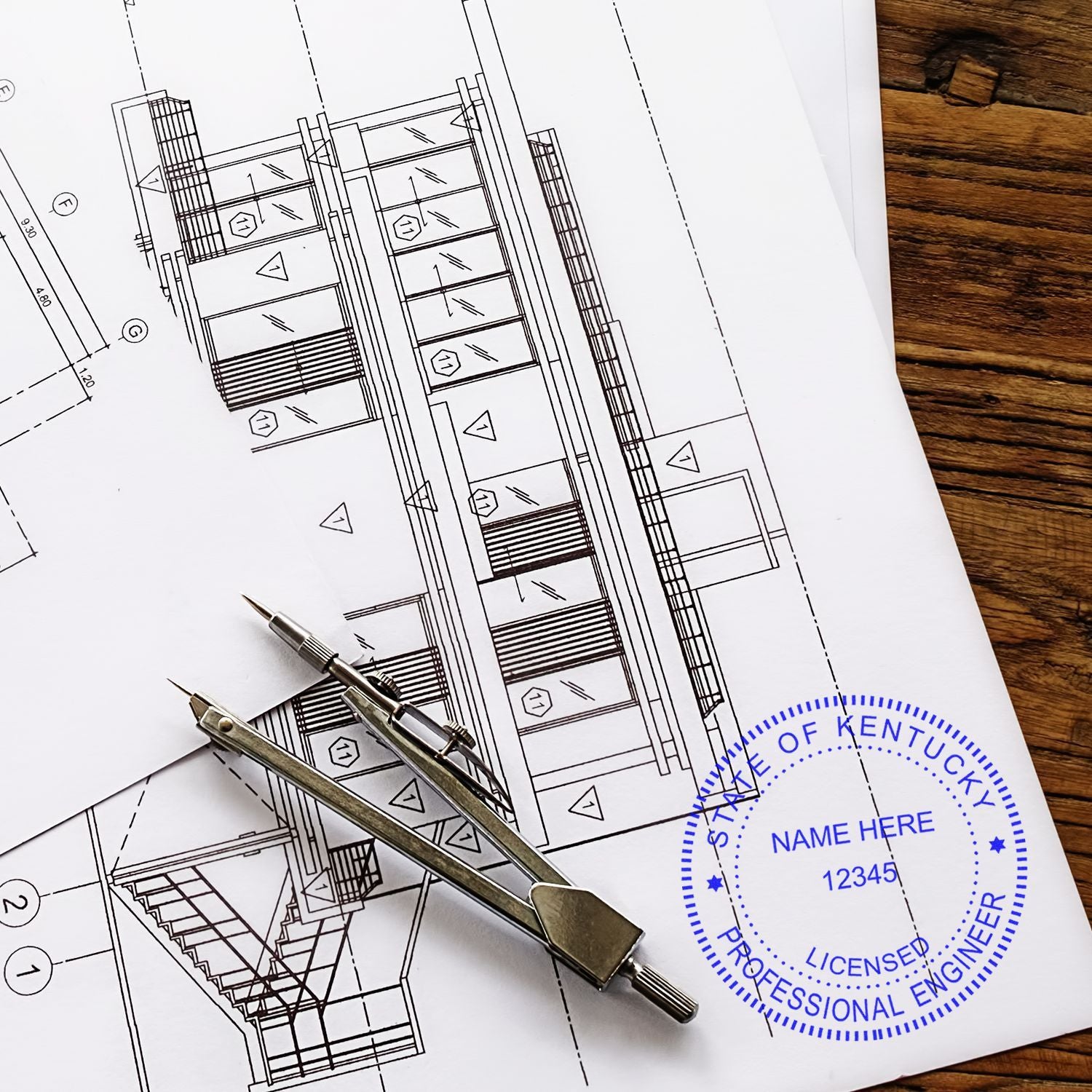 Architectural blueprints with drafting compass and professional engineer stamp on a wooden desk.