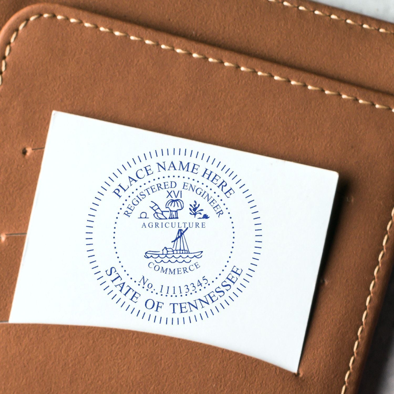 Close-up of a brown leather wallet with a Tennessee state seal embossed card insert.