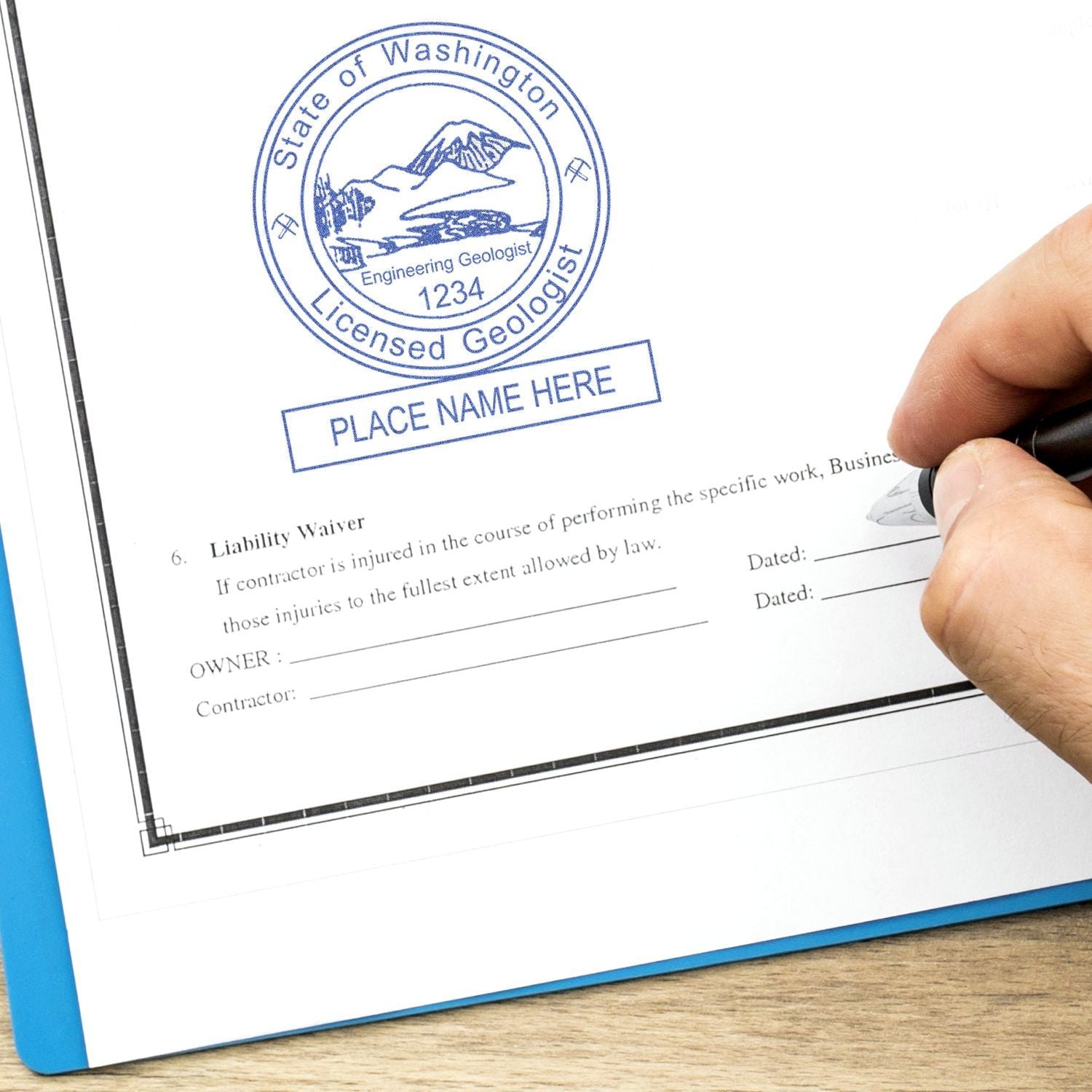 Hand signing a liability waiver with a Washington State licensed geologist seal on a professional contract document.