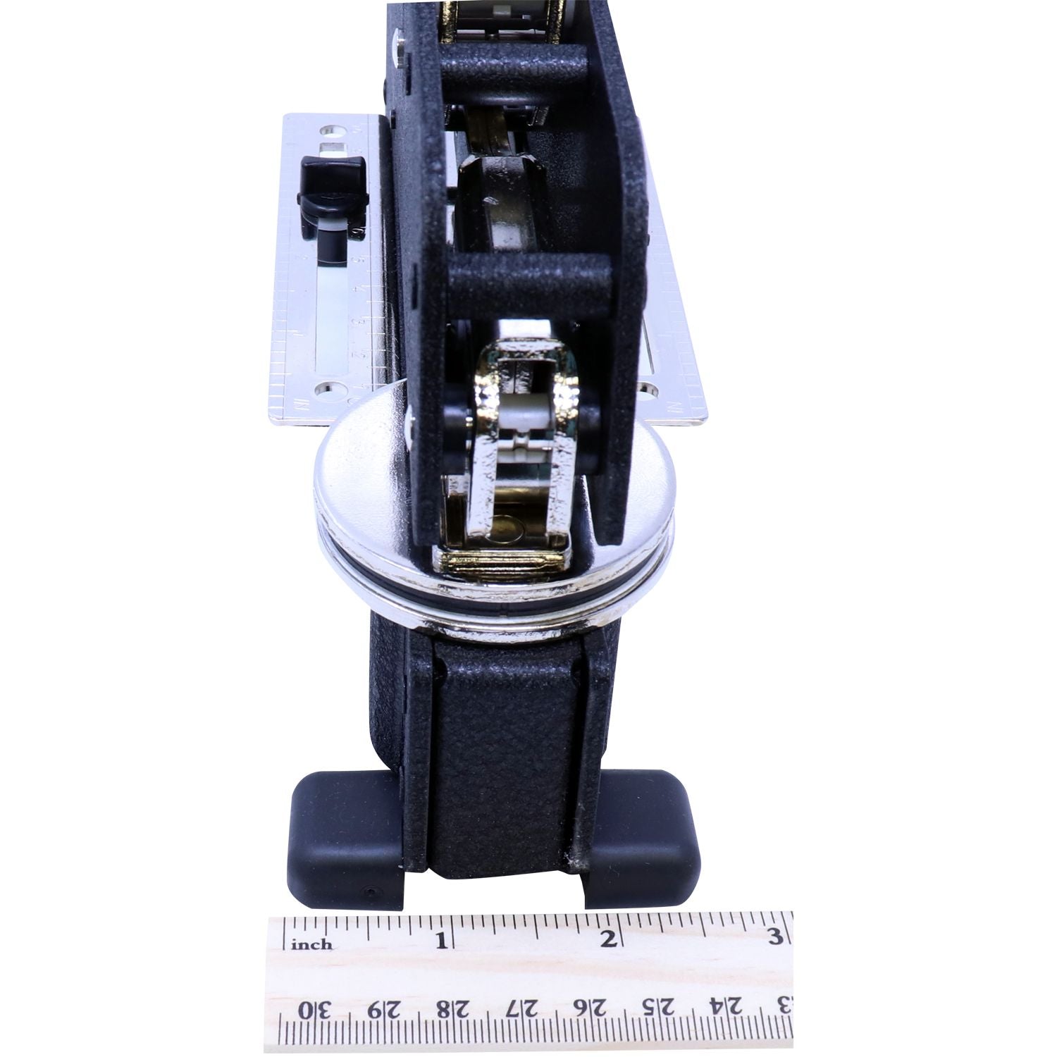 Close-up of a black and silver mechanical hinge assembly with ruler for size reference on a white background.