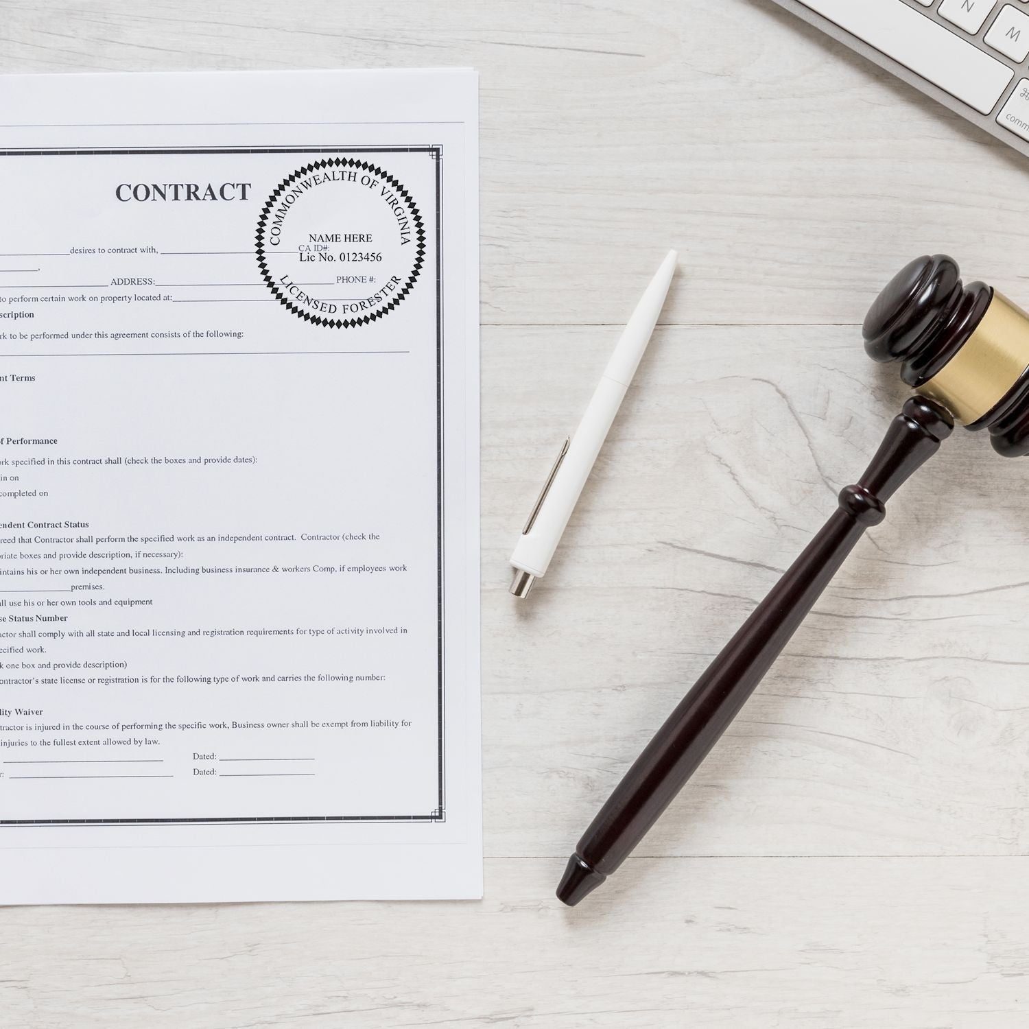 Legal contract document with pen and gavel on desk, business agreement and licensing paperwork concept