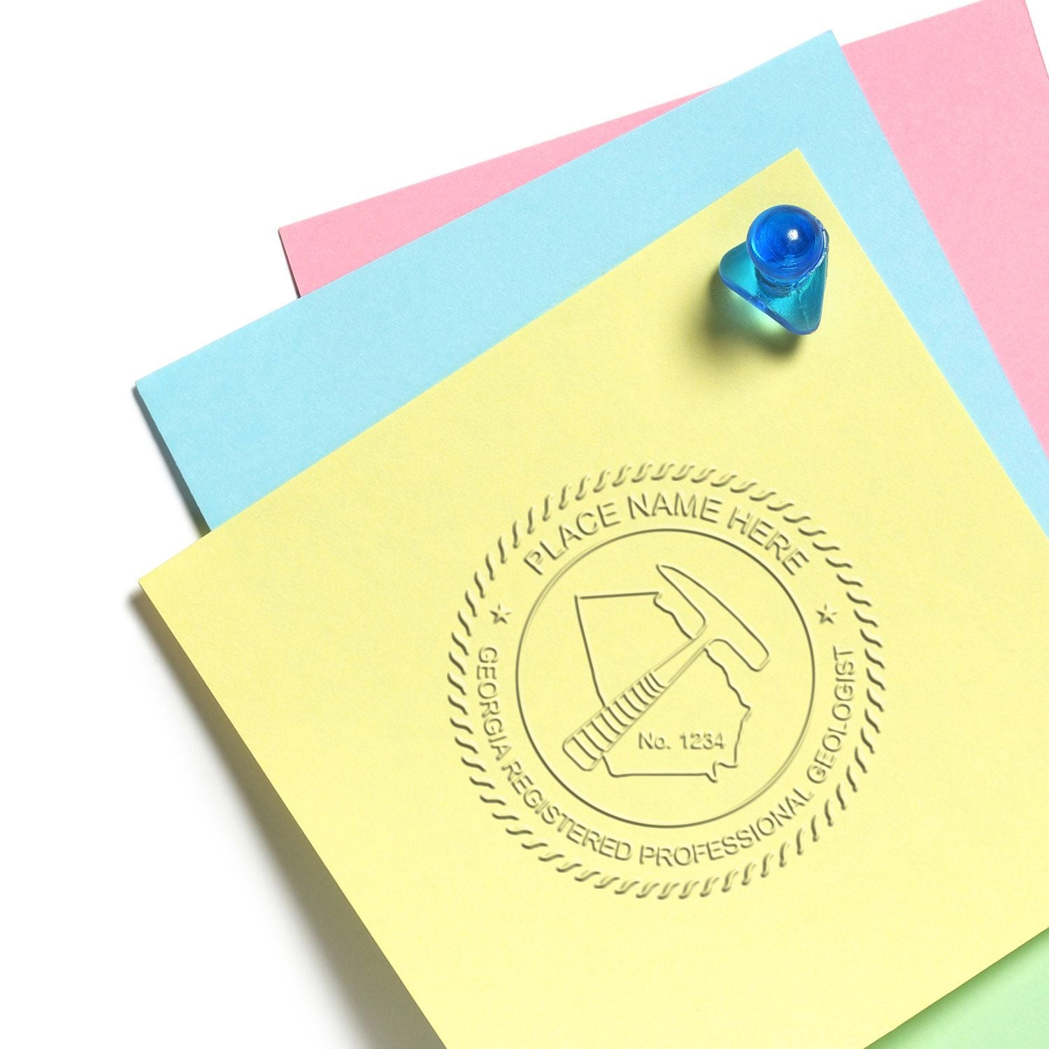 Pastel sticky notes with embossed professional geologist stamp and blue pushpin on white background