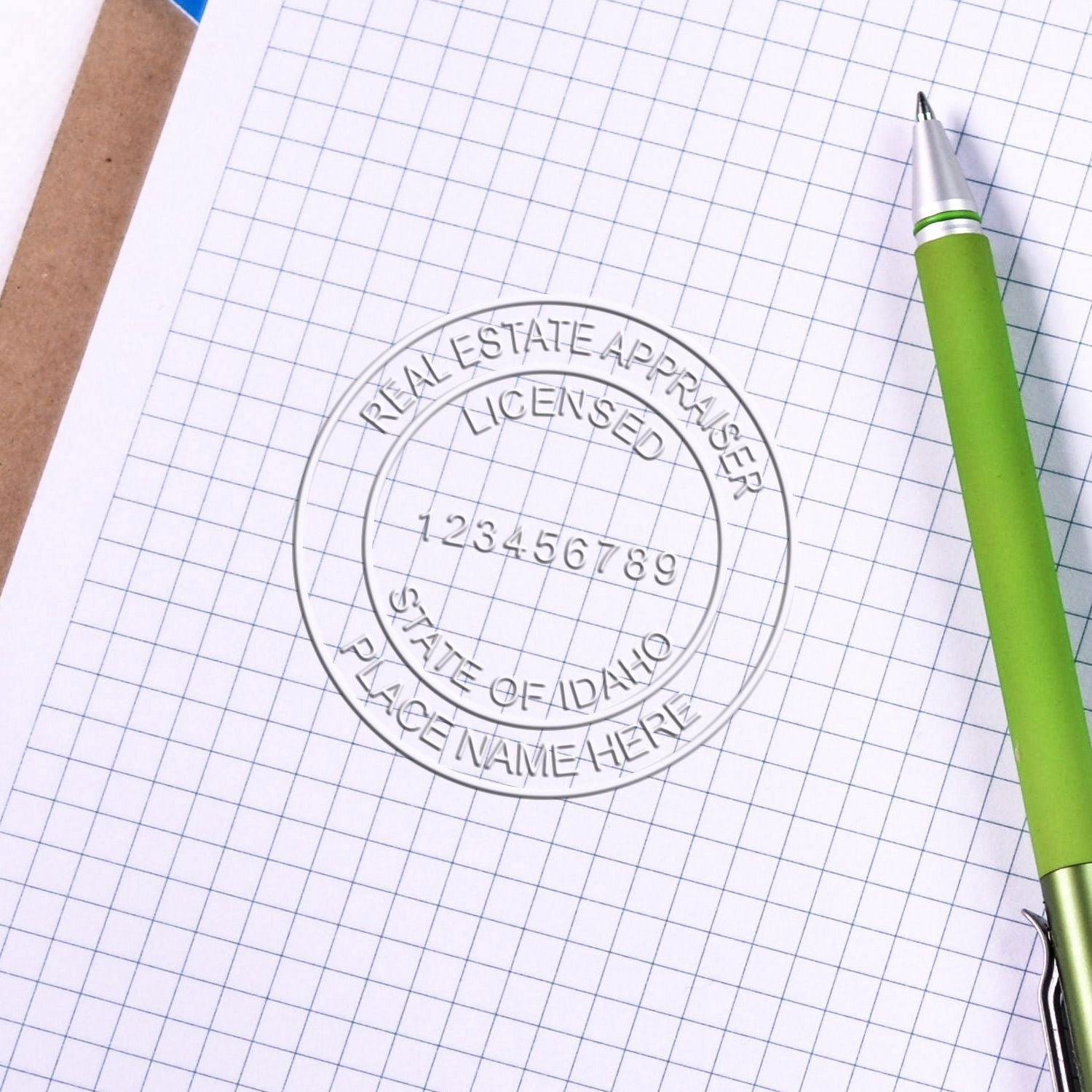 Real estate appraisal licensed state of Idaho stamp on graph paper with green pen.